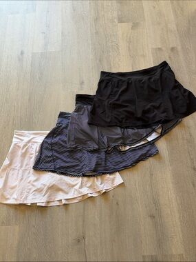 Four-Pack Women’s Tennis Skorts — White, Navy Stripe, Black Stripe & Black